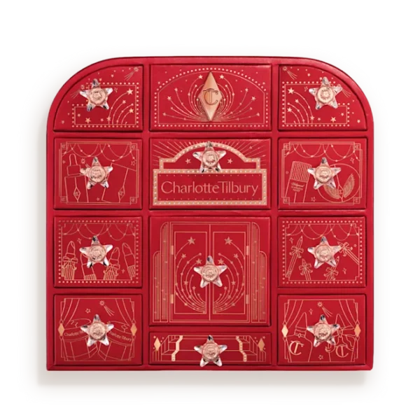 Red Charlotte Tilbury advent calendar with 12 numbered door compartments and star decorations, all closed.