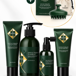 Hadat Detox Therapy hair care set in dark green bottles and tubes on a marble pedestal, with a gift-set circle in the background.