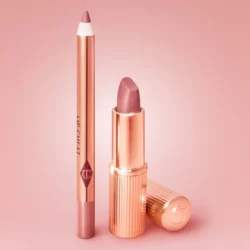 Mini-Pillow-Talk-Set---Creative-Stilljpg - shopcosmoprof.com Rose-gold lipstick with its cap beside a matching lip liner pencil on a pink background.