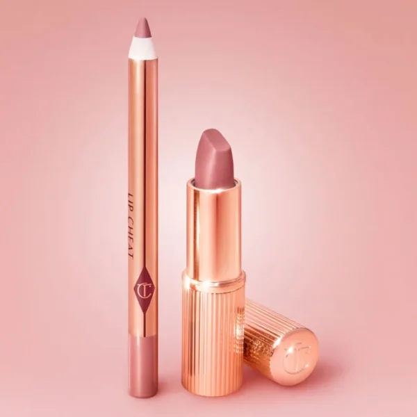 Rose-gold lipstick with its cap beside a matching lip liner pencil on a pink background.