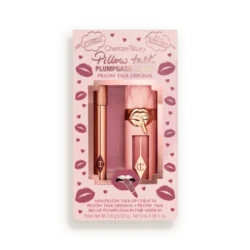 Pink Charlotte Tilbury Pillow Talk lip kit packaging with two rose-gold lip products visible through a window, surrounded by lip-print designs inside a pale tin.