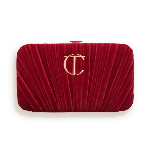 Red velvet pleated clutch bag with a gold interlocking logo on the front, suitable for evening wear.
