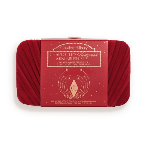 Red makeup brush set in a white tray with a red Charlotte Tilbury box labeled 'Hollywood Mini Brush Set' in the center.