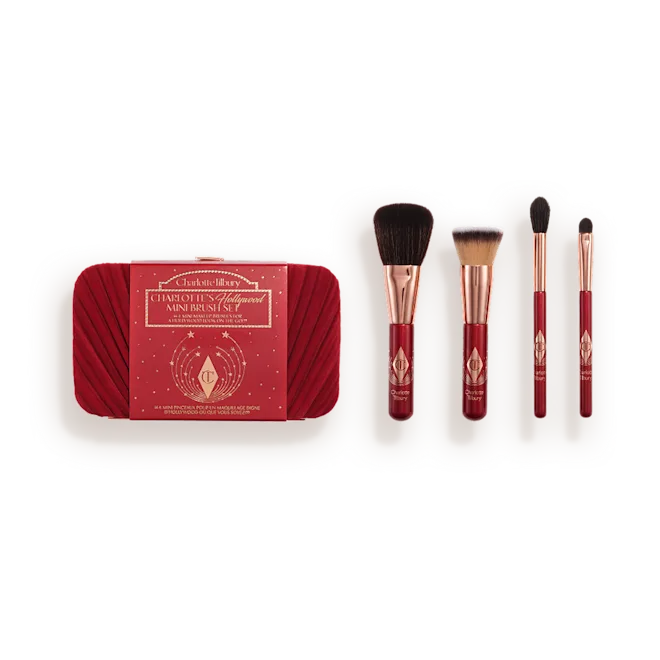 Charlotte Tilbury makeup brush set in a red case with four brushes laid out beside it.