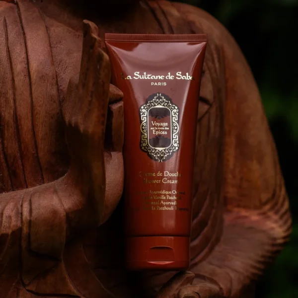 Shower cream tube labeled La Sulwane de Saba Voyage sur la route des Epices with ornate gold emblem on a burgundy tube