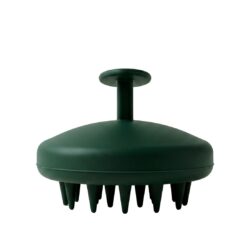 Green silicone scalp massager with a round, flat head and several soft bristle-like prongs, mounted on a short stem with a circular top handle.